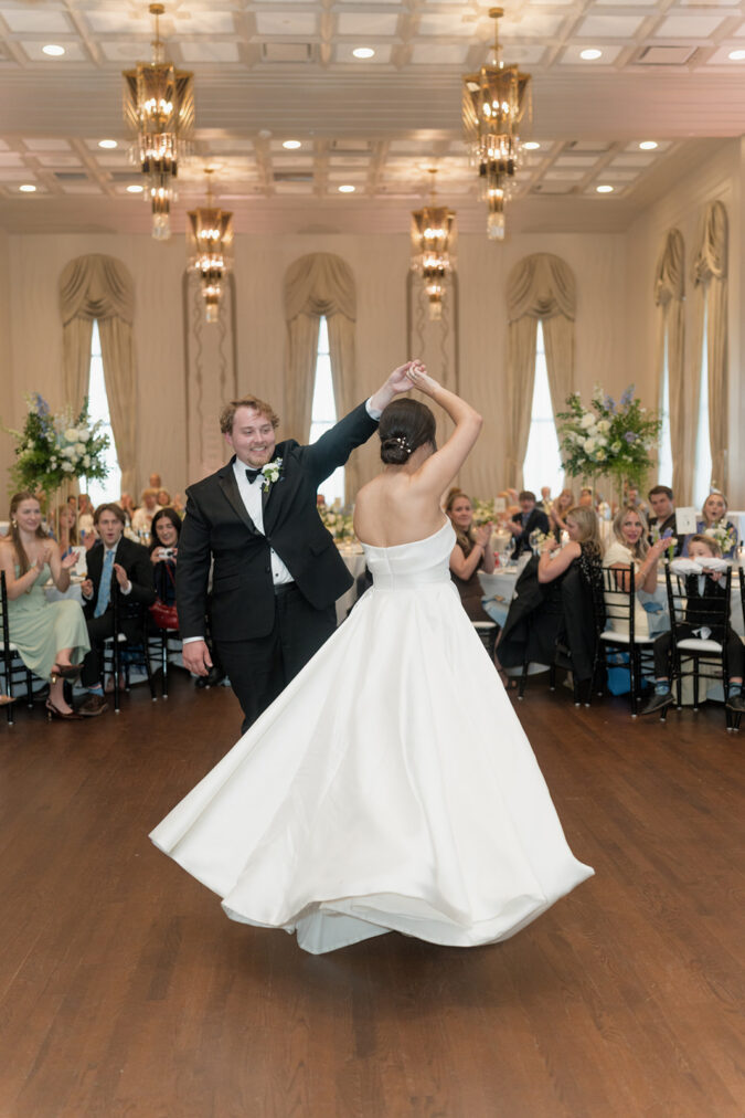 Newlywed couple takes their first dance at the Tulsa Club Hotel.