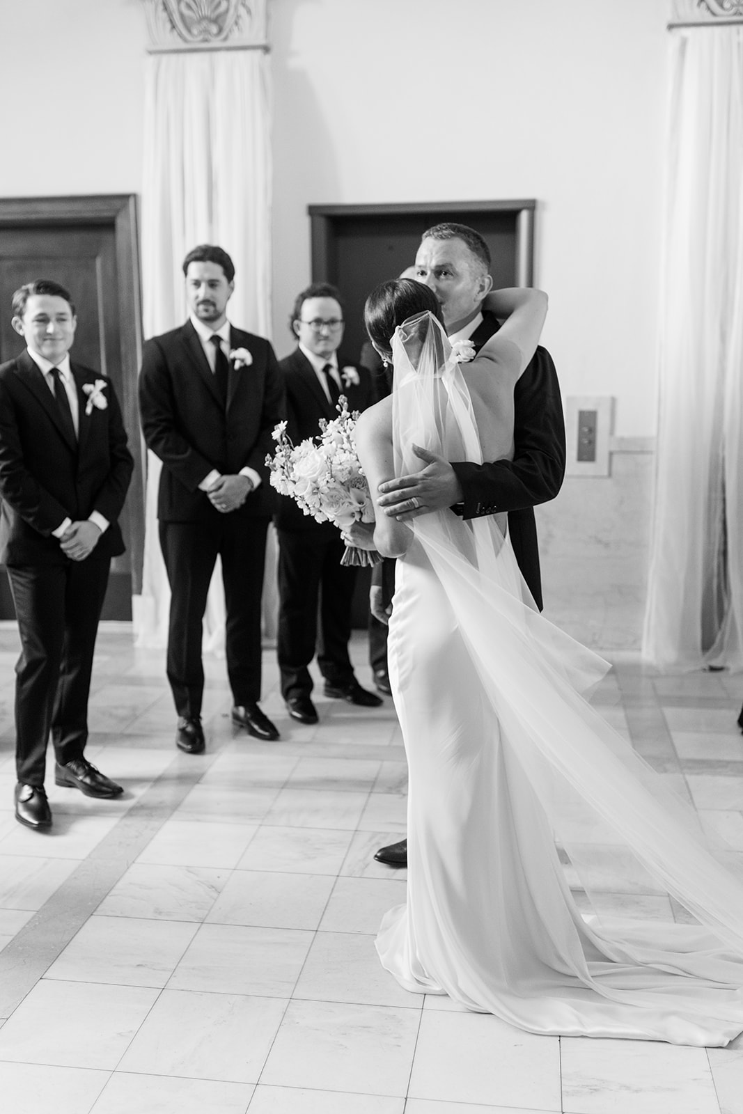 Black and white photo of the bride hugging her father after walking down the aisle, Oklahoma City wedding photography