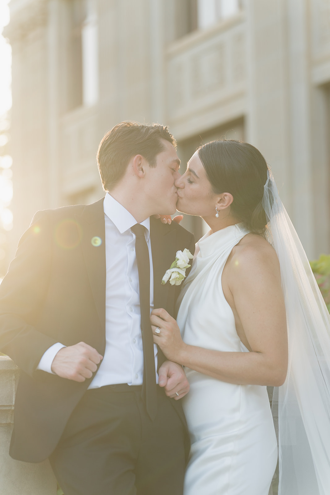 Newlyweds sharing their first kiss during the ceremony at the Oklahoma Hall of Fame in Oklahoma City, Oklahoma wedding photography