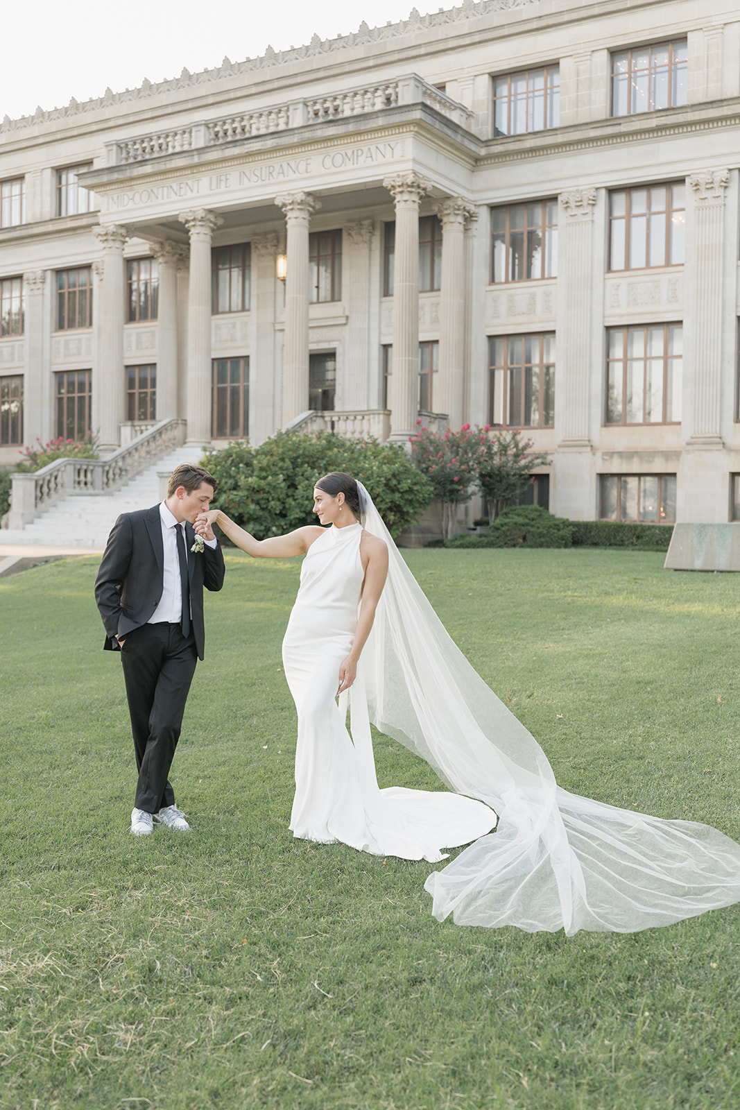 Candid veil portrait of the newlyweds outside the Oklahoma Hall of Fame, Oklahoma City wedding photography