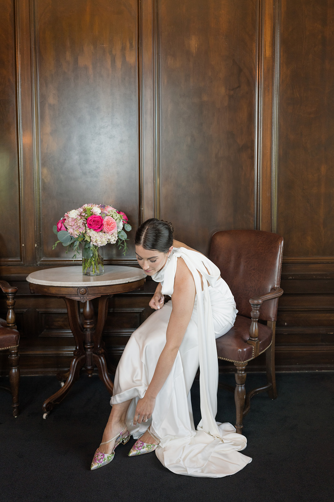 Styled editorial wedding portrait with white backdrop at the Oklahoma Hall of Fame, Oklahoma City