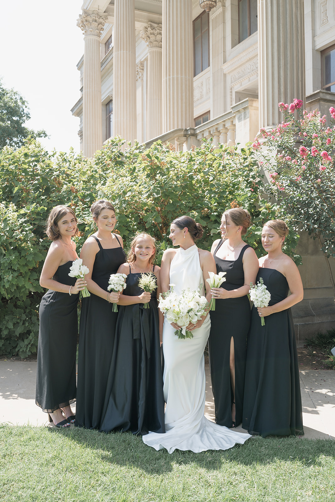 Back view bridal portrait with bouquet at the white backdrop outside the Oklahoma Hall of Fame, Oklahoma City wedding photography