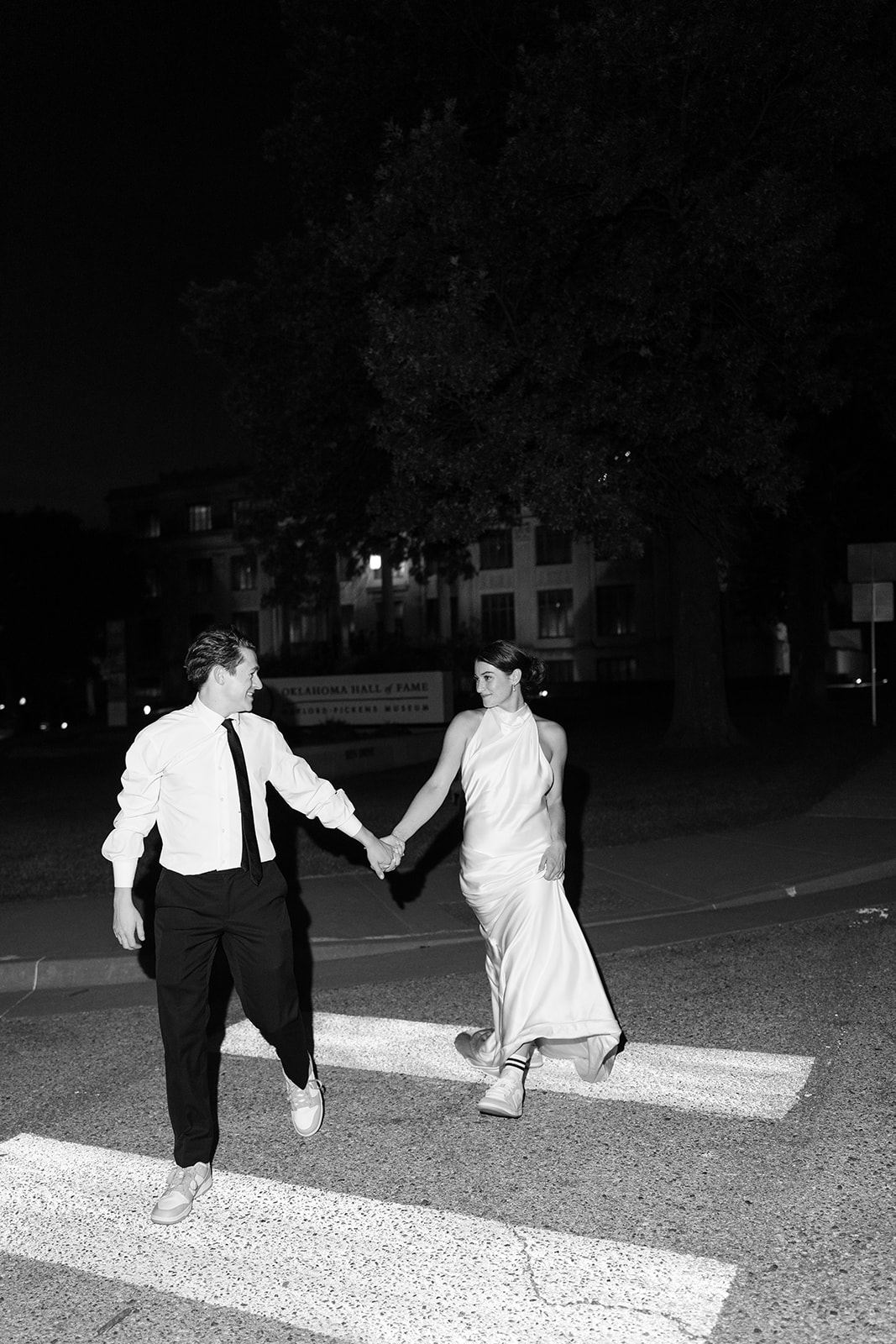 Black and white night portrait of the couple in the crosswalk after their Oklahoma City wedding, moody Oklahoma wedding photographer